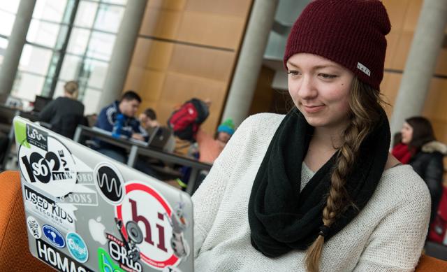 Ohio State student working on laptop in Thompson Library.