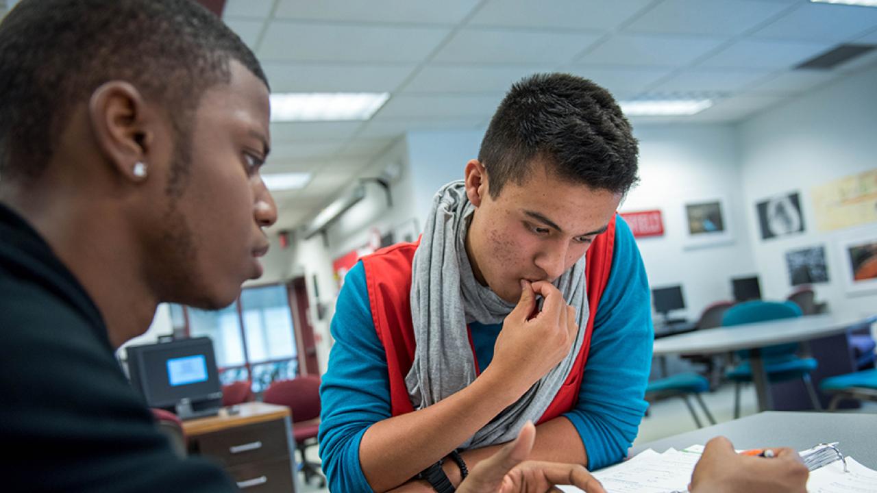 two students studying in a bright, well-lit room